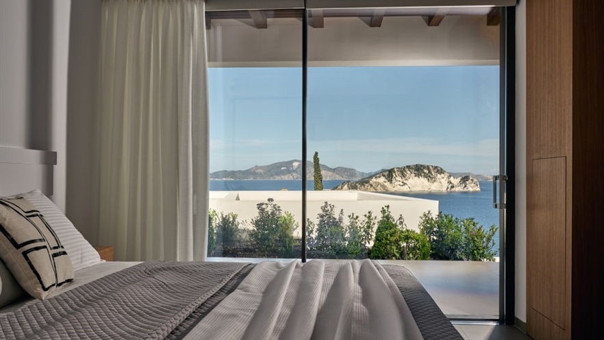 Bed with view to the sea through the aluminum window