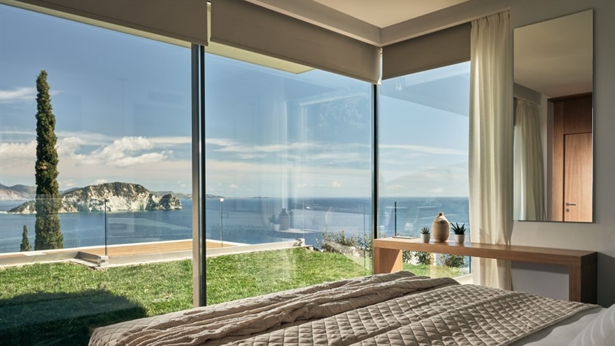 View to the sea from the bed, through the aluminum window