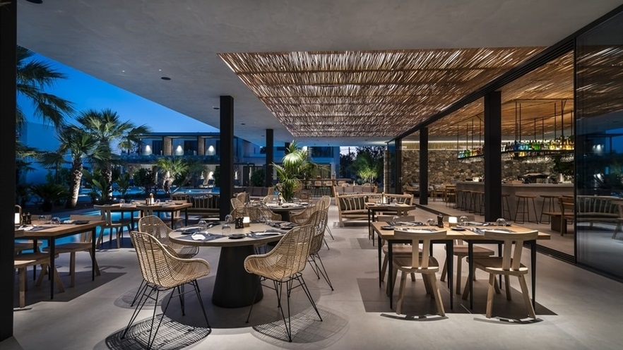 Outdoor area with tables and chairs by night